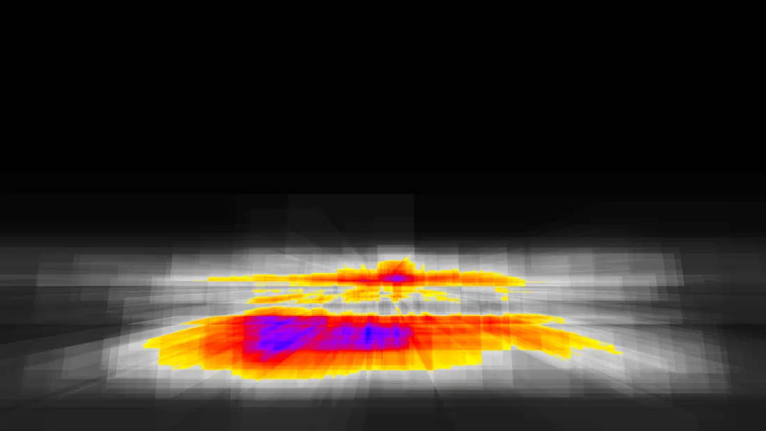 The same scene as a heat map: dark far from the spheres, grey around them and red, yellow and blue where the rays cross the densest part
